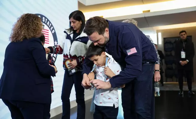 Vice President JD Vance holds his son Vivek's credentials, at the Team USA Welcome Experience, ahead of the Milano Cortina 2026 Winter Olympics in Milan, Italy, Thursday, Feb. 5, 2026. (Kevin Lamarque/Pool Photo via AP)