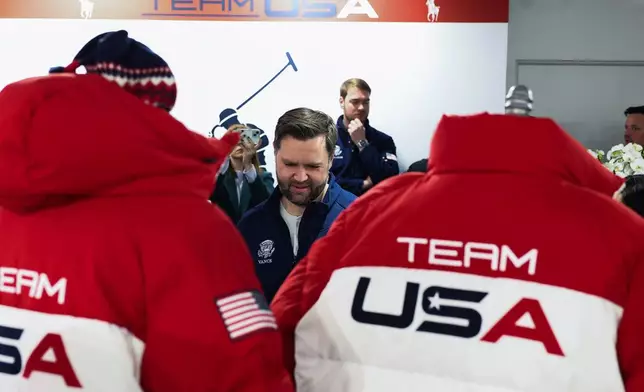 Vice President JD Vance stands by Team USA jackets, at the Team USA Welcome Experience, ahead of the Milano Cortina 2026 Winter Olympics in Milan, Italy, Thursday, Feb. 5, 2026. (Kevin Lamarque/Pool Photo via AP)