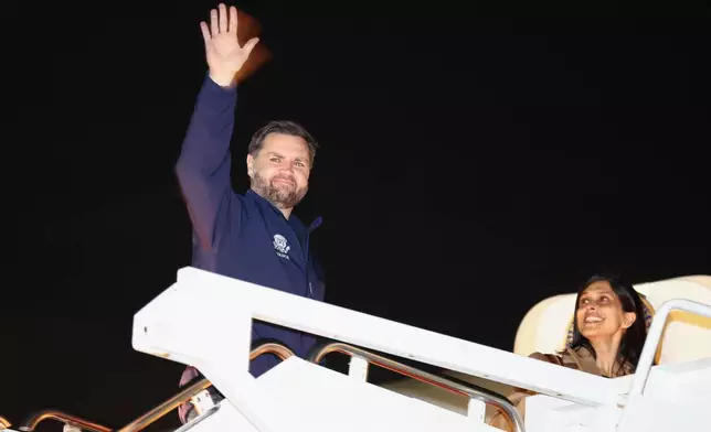 Vice President JD Vance waves as he and second lady Usha Vance board Air Force Two to travel to the Milano Cortina 2026 Winter Olympics in Italy, from Joint Base Andrews, Md., Feb. 4, 2026. (Kevin Lamarque/Pool via AP)