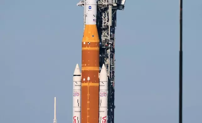 NASA's Artemis II SLS (Space Launch System) moon rocket with the Orion spacecraft slowly rolls back towards the Vehicle Assembly Building at the Kennedy Space Center, Wednesday, Feb. 25, 2026, in Cape Canaveral, Fla. (AP Photo/John Raoux)