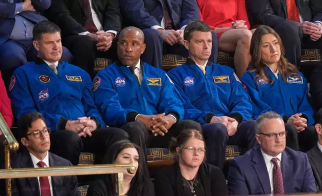 Astronauts for the upcoming Artemis II mission listen as President Donald Trump delivers the State of the Union address to a joint session of Congress in the House chamber at the U.S. Capitol in Washington, Tuesday, Feb. 24, 2026. (AP Photo/Mark Schiefelbein)