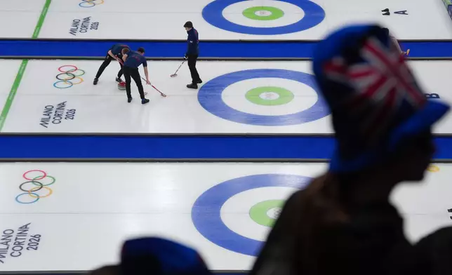 Britain's Bruce Mouat, Grant Hardie and Bobby Lammie competes in a men's curling semifinal match against Switzerland at the 2026 Winter Olympics, in Cortina d'Ampezzo, Italy, Thursday, Feb. 19, 2026. (AP Photo/Misper Apawu)