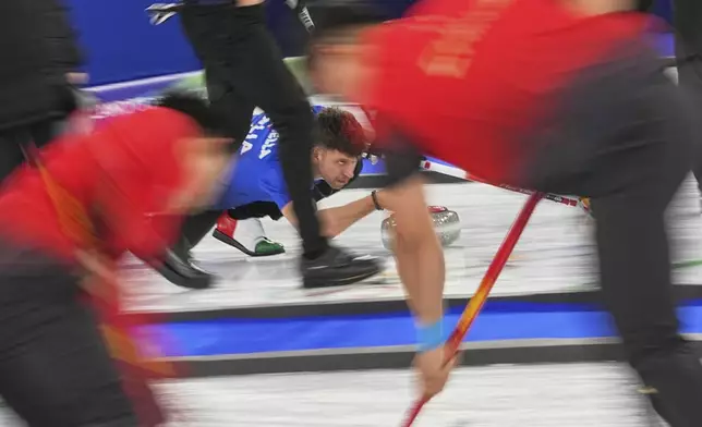 Italy's Mattia Giovanella in action during the men's curling round robin session against Switzerland at the 2026 Winter Olympics, in Cortina d'Ampezzo, Italy, Thursday, Feb. 19, 2026. (AP Photo/Fatima Shbair)