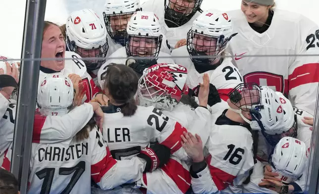 Team Switzerland players celebrate after beating Sweden 2-1 in overtime to win the women's ice hockey bronze medal game at the 2026 Winter Olympics, in Milan, Italy, Thursday, Feb. 19, 2026. (AP Photo/Carolyn Kaster)
