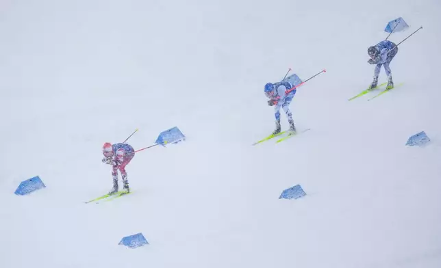 Johannes Lamparter, of Austria, from left, Eero Hirvonen, of Finland, and Ryota Yamamoto, of Japan, compete in the nordic combined team sprint at the 2026 Winter Olympics, in Tesero, Italy, Thursday, Feb. 19, 2026. (AP Photo/Evgeniy Maloletka)