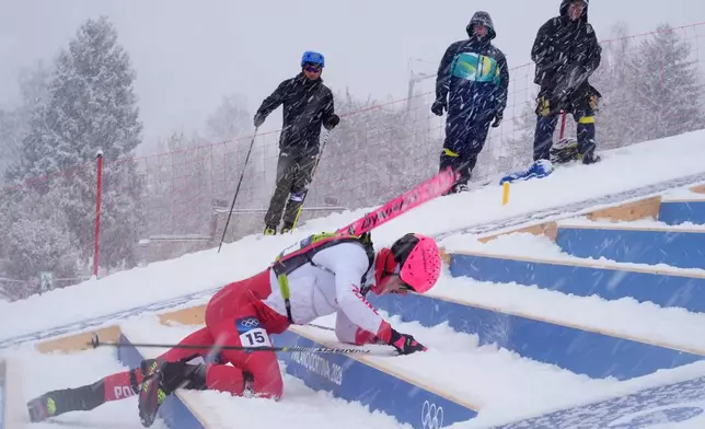 Poland's Jan Elantkowski falls as he competes during a ski mountaineering men's sprint heat, at the 2026 Winter Olympics, in Bormio, Italy, Thursday, Feb. 19, 2026. (AP Photo/Rebecca Blackwell)