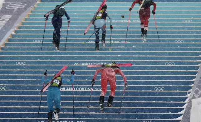 Athletes, including Italy's Alba de Silvestro, bottom left, compete during a ski mountaineering women's sprint heat, at the 2026 Winter Olympics, in Bormio, Italy, Thursday, Feb. 19, 2026. (AP Photo/Gabriele Facciotti)