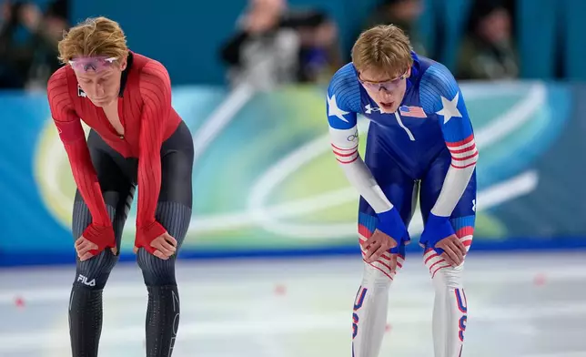 Jordan Stolz of the U.S., right, and Peder Kongshaug of Norway catch their breath after competing in the men's 1500 meters speedskating race at the 2026 Winter Olympics, in Milan, Italy, Thursday, Feb. 19, 2026. (AP Photo/Ben Curtis)