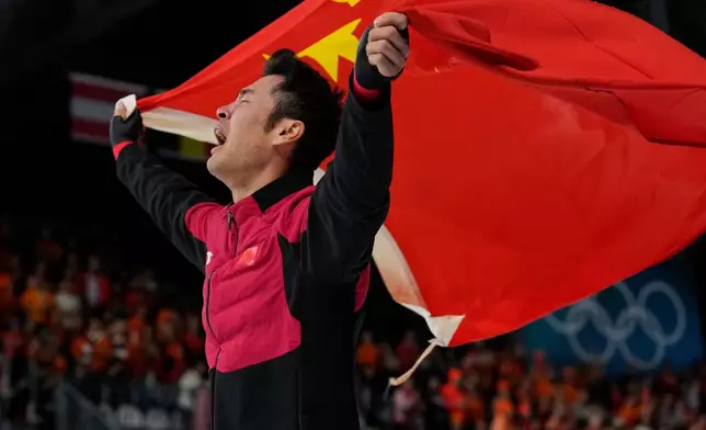 Ning Zhongyan of China celebrates winning the gold medal in the men's 1500 meters speedskating race at the 2026 Winter Olympics, in Milan, Italy, Thursday, Feb. 19, 2026. (AP Photo/Luca Bruno)