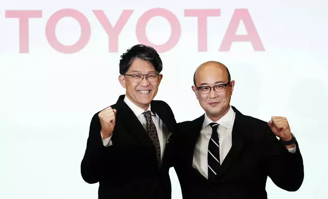 Kenta Kon, right, an executive officer who has been named the next president of Toyota Motor Corp., poses for a photo with current President Koji Sato, left, in Tokyo on Friday, Feb. 6, 2026. (Yohei Fukai/Kyodo News via AP)