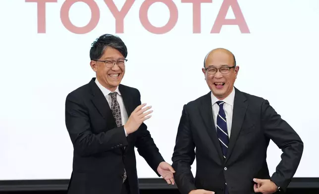 Kenta Kon, right, an executive officer who has been named the next president of Toyota Motor Corp., poses for a photo with current President Koji Sato, left, in Tokyo on Friday, Feb. 6, 2026. (Yohei Fukai/Kyodo News via AP)