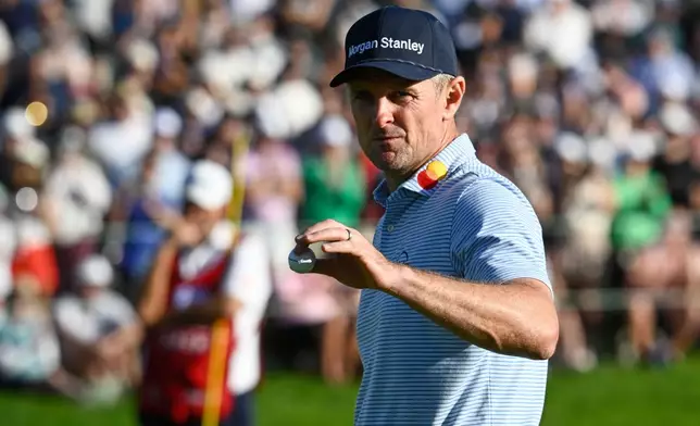 Justin Rose, of England, walks off the 18th green of the South Course at Torrey Pines during the third round of the Farmers Insurance Open golf tournament Saturday, Jan. 31, 2026, in San Diego. (AP Photo/Denis Poroy)