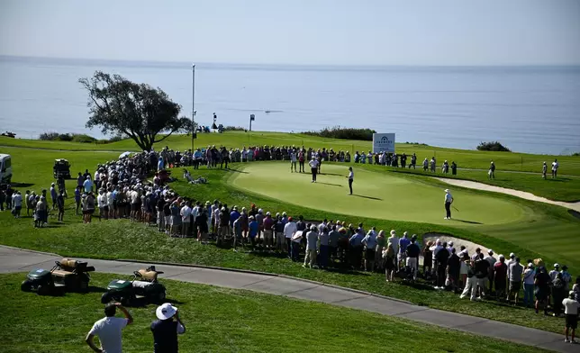 Justin Rose, of England, lines up his putt on the fifth green of the South Course at Torrey Pines during the third round of the Farmers Insurance Open golf tournament Saturday, Jan. 31, 2026, in San Diego. (AP Photo/Denis Poroy)