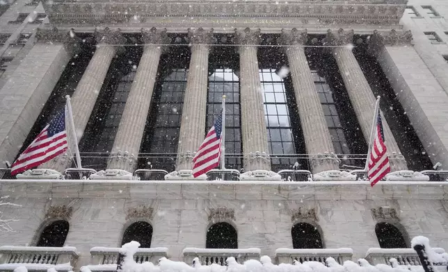 Snow falls outside the New York Stock Exchange, Monday, Feb. 23, 2026, in New York. (AP Photo/Seth Wenig)