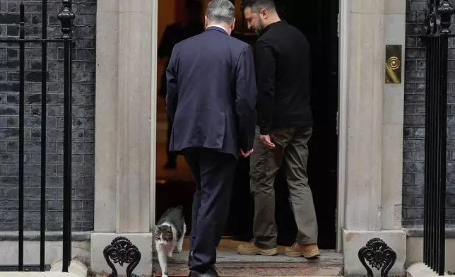 Britain's Prime Minister Keir Starmer welcomes Ukrainian President Volodymyr Zelenskyy to 10 Downing Street as Larry the cat, Chief Mouser to the Cabinet Office, steps out in London, Thursday, Oct. 10, 2024. (AP Photo/Alastair Grant, File)
