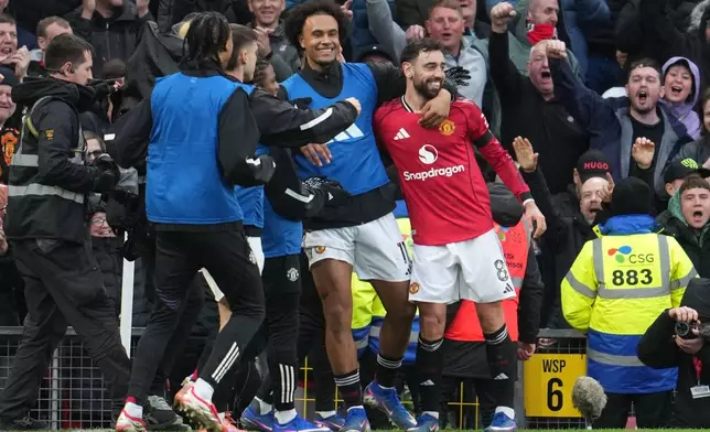 Manchester United's Bruno Fernandes celebrates after scoring during the English Premier League soccer match between Manchester United and Tottenham in Manchester, England, Saturday, Feb. 7, 2026. (AP Photo/Jon Super)