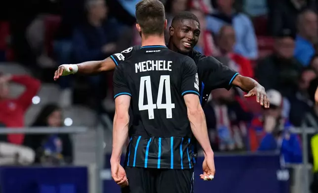 Brugge's Joel Ordonez, background, celebrates after scoring his side's first goal during the Champions League play-off second leg soccer match between Atletico Madrid and Club Brugge, in Madrid, Spain, Tuesday, Feb. 24, 2026. (AP Photo/Manu Fernandez)