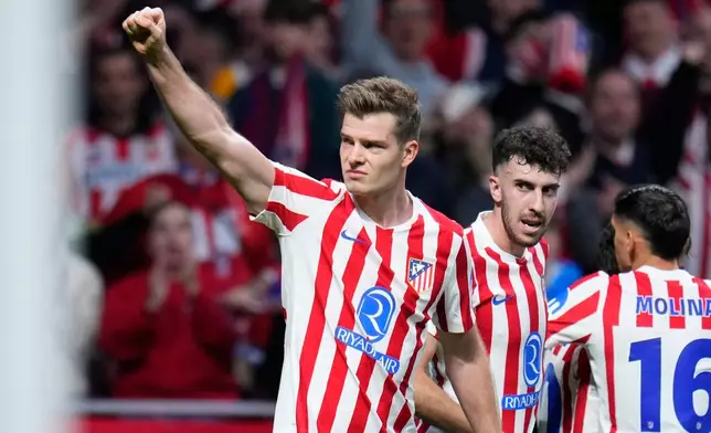 Atletico Madrid's Alexander Sorloth celebrates after scoring his side's third goal during the Champions League play-off second leg soccer match between Atletico Madrid and Club Brugge, in Madrid, Spain, Tuesday, Feb. 24, 2026. (AP Photo/Manu Fernandez)