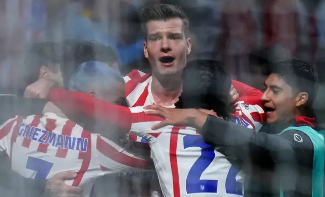 Atletico Madrid's Alexander Sorloth, center, celebrates after scoring his side's third goal during the Champions League play-off second leg soccer match between Atletico Madrid and Club Brugge, in Madrid, Spain, Tuesday, Feb. 24, 2026. (AP Photo/Manu Fernandez)