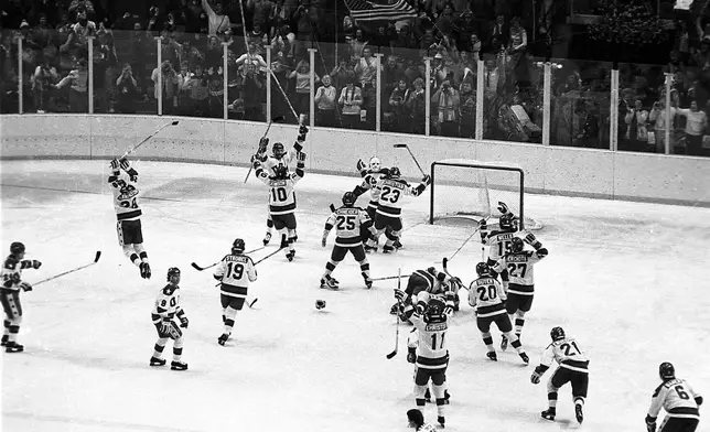 FILE - In this Feb. 22, 1980, file photo, the U.S. ice hockey team rushes toward goalie Jim Craig after their 4-3 upset win over the Soviet Union in a medal round match at the Winter Olympics in Lake Placid, N.Y. (AP Photo/File)