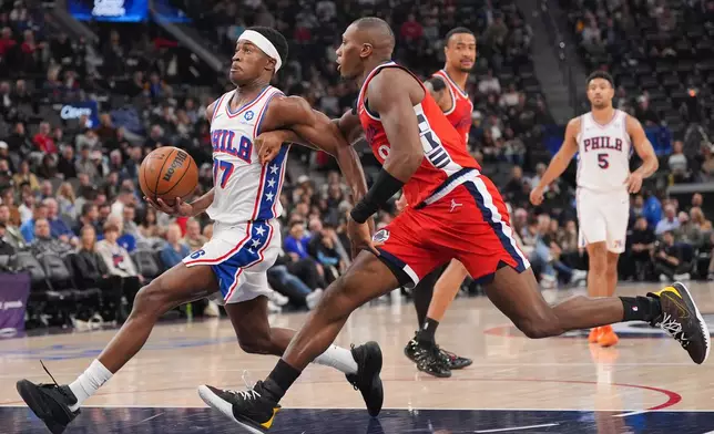 Los Angeles Clippers guard Kris Dunn (8) pressures Philadelphia 76ers guard Vj Edgecombe (77) during the first half of an NBA basketball game Monday, Feb. 2, 2026, in Inglewood, Calif. (AP Photo/Jae C. Hong)