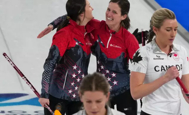 United States' Tabitha Peterson, and Tara Peterson react after the women's curling round robin session against Canada, at the 2026 Winter Olympics, in Cortina d'Ampezzo, Italy, Friday, Feb. 13, 2026. (AP Photo/Misper Apawu)