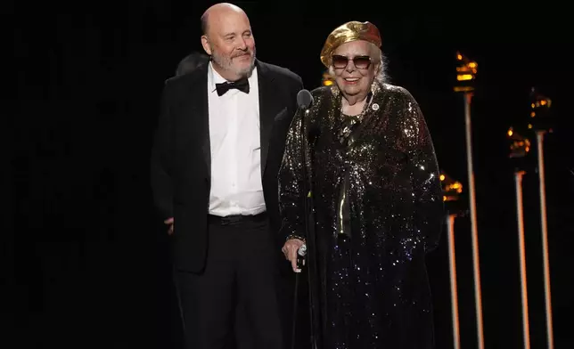 Patrick Milligan, left, and Joni Mitchell accept the award for best historical album for "Joni Mitchell Archives - Volume 4: The Asylum Years (1976–1980)" during the 68th annual Grammy Awards on Sunday, Feb. 1, 2026, in Los Angeles. (AP Photo/Chris Pizzello)