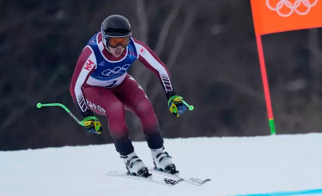 Canada's James Crawford speeds down the course during an alpine ski, men's downhill official training, at the 2026 Winter Olympics, in Bormio, Italy, Friday, Feb. 6, 2026. (AP Photo/Julia Demaree Nikhinson)