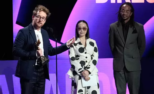 Clint Bentley accepts the award for best director for "Train Dreams" during the Film Independent Spirit Awards on Sunday, Feb. 15, 2026, at the Hollywood Palladium in Los Angeles. Lulu Wang looks on from right.(AP Photo/Chris Pizzello)