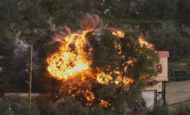 Flames rise from a building that was hit by an Israeli airstrike in Ain Qana village, south Lebanon, Monday, Feb. 2, 2026. (AP Photo/Mohammed Zaatari)