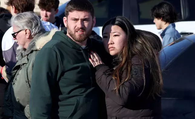 Hockey fans react near the Lynch Arena in Pawtucket, R.I., after a shooting at the ice rink, Monday, Feb. 16, 2026. (AP Photo/Mark Stockwell)