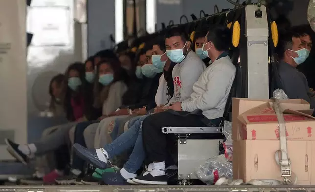FILE - Migrants wearing face masks and shackles on their hands and feet sit on a military aircraft at Fort Bliss in El Paso, Tx., Jan. 30, 2025, awaiting their deportation to Guatemala. (AP Photo/Christian Chavez, File)