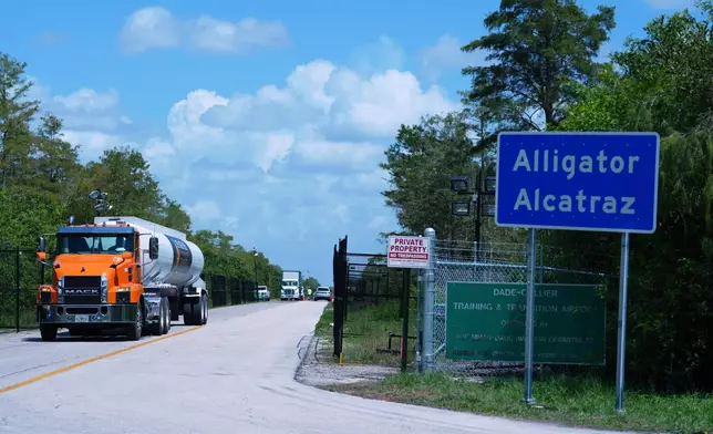 FILE - Trucks come and go from the "Alligator Alcatraz" immigration detention center in the Florida Everglades, Thursday, Aug. 28, 2025, in Collier County, Fla. (AP Photo/Rebecca Blackwell,File)