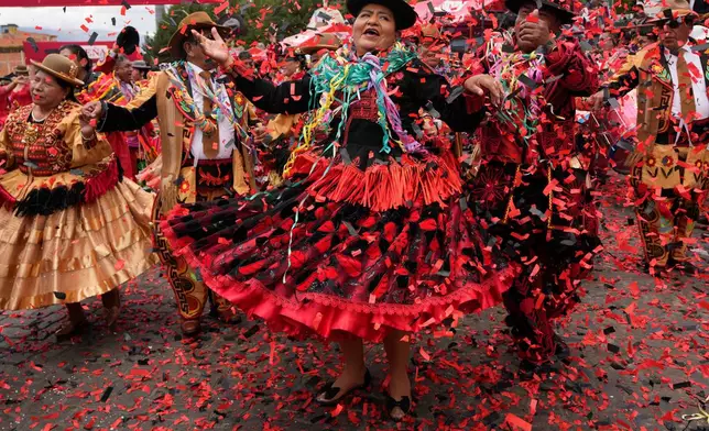 Dancers dressed as the traditional characters of Chola and Chuta perform at Carnival closing ceremonies in La Paz, Bolivia, Sunday, Feb. 22, 2026. (AP Photo/Juan Karita)