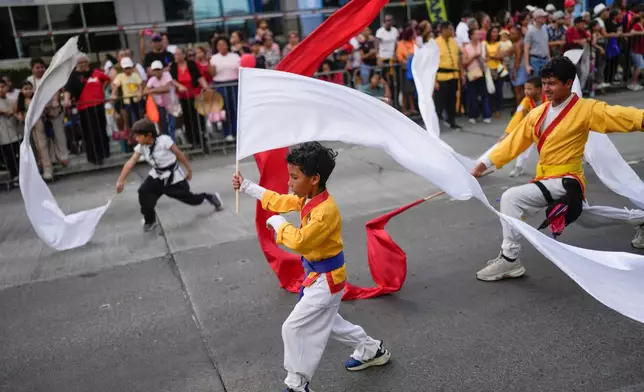 People perform during a parade celebrating the Lunar New Year in Panama City, Sunday, Feb. 22, 2026. (AP Photo/Matias Delacroix)