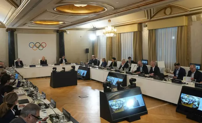 IOC President Kirsty Coventry, top center, sits at the head of the table at the start of the IOC Executive Board meeting at the 2026 Winter Olympics, in Milan, Italy, Saturday, Jan. 31, 2026. (AP Photo/Antonio Calanni, Pool)