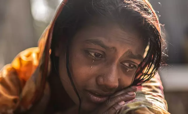 FILE - Meghna Rani, wife of Dipu Chandra Das who was beaten to death by a mob, his body hung from a tree and set on fire, for alleging making derogatory remarks about the Prophet Muhammad, weeps inside her home in Tarakanda, Bangladesh, Jan. 9, 2026. (AP Photo/Mahmud Hossain Opu, File)