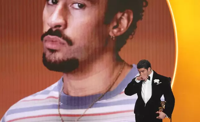 FILE - Bad Bunny accepts the award for album of the year for "Debí Tirar Más Fotos" during the 68th annual Grammy Awards in Los Angeles, Feb. 1, 2026. (AP Photo/Chris Pizzello, File)