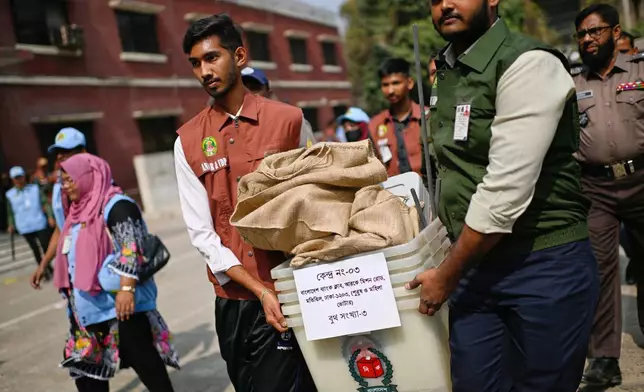 Election officials and security personnel transport ballot boxes and voting materials to polling centers ahead of Thursday's national parliamentary election, in Dhaka, Bangladesh, Wednesday, Feb. 11, 2026. (AP Photo/Mahmud Hossain Opu)