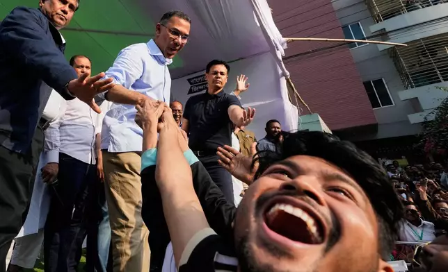 Tarique Rahman, the son of former Prime Minister Khaleda Zia and chairman of the Bangladesh Nationalist Party (BNP), shakes hands with a fan during an election rally ahead of national election, in Dhaka, Bangladesh, Sunday, Feb. 8, 2026. (AP Photo/Anupam Nath)