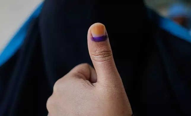 A Bangladeshi woman shows indelible ink mark on her thumb after casting her vote in a polling station during national parliamentary election in Dhaka, Bangladesh, Thursday, Feb. 12, 2026. (AP Photo/Anupam Nath)