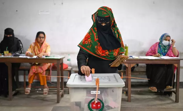 A woman casts her vote at a polling station during Bangladesh's national parliamentary election, in Dhaka, Bangladesh, Thursday, Feb. 12, 2026. (AP Photo/Mahmud Hossain Opu)