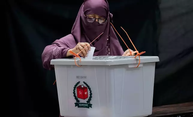 A Bangladeshi woman casts her vote in a polling station during national parliamentary election in Dhaka, Bangladesh, Thursday, Feb. 12, 2026. (AP Photo/Anupam Nath)