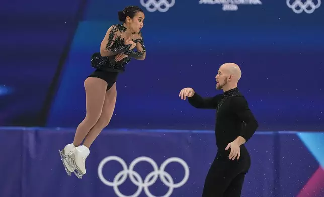 Ellie Kam and Danny O'Shea of the United States compete during the figure skating pairs team event at the 2026 Winter Olympics, in Milan, Italy, Sunday, Feb. 8, 2026. (AP Photo/Stephanie Scarbrough)