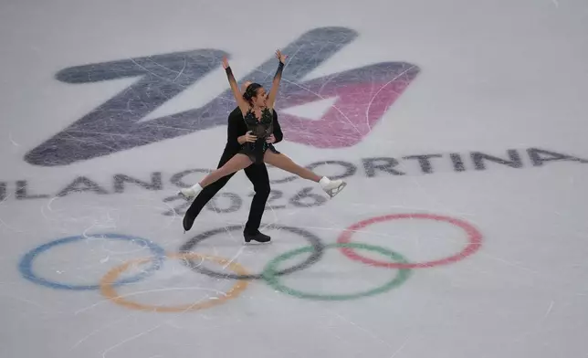 Ellie Kam and Danny O'Shea of the United States compete during the figure skating pairs team event at the 2026 Winter Olympics, in Milan, Italy, Sunday, Feb. 8, 2026. (AP Photo/Natacha Pisarenko)