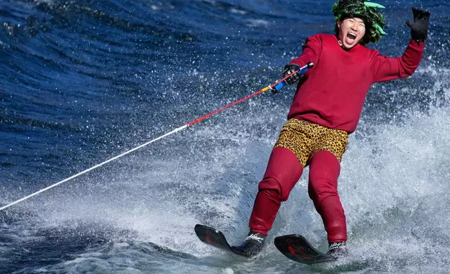 A student depicting "Oni", demon-like figures in Japanese folklore, skims across the water on water skis during the annual Bean Throwing Festival near Hakone Shrine in Hakone, Japan, Tuesday, Feb. 3, 2026. (AP Photo/Eugene Hoshiko)