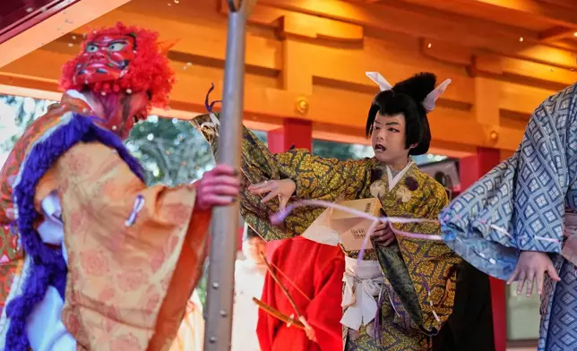 Lucky beans are thrown on an 'Oni', or demon-like figures in Japanese folklore, during the annual Bean Throwing Festival at Hakone Shrine in Hakone, Japan, Tuesday, Feb. 3, 2026. (AP Photo/Eugene Hoshiko)