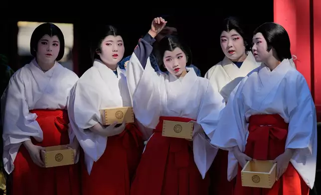 Local students dressed as shrine maidens participate in the annual Bean Throwing Festival in Hakone, Japan, Tuesday, Feb. 3, 2026. (AP Photo/Eugene Hoshiko)