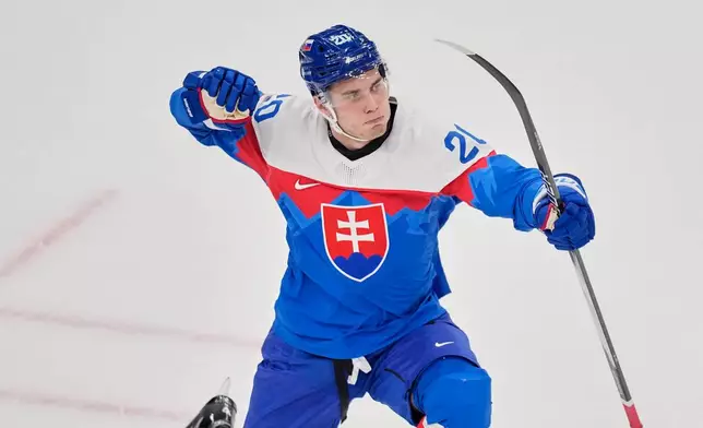 Slovakia's Juraj Slafkovsky celebrates after scoring her side's opening goal during a preliminary round match of men's ice hockey between Slovakia and Finland at the 2026 Winter Olympics, in Milan, Italy, Wednesday, Feb. 11, 2026. (AP Photo/Petr David Josek)