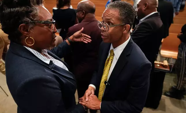 Former Illinois Rep. Jesse Jackson Jr., right, speaks to Knitasha Washington during an event where he was endorsed by the Southland Minister Alliance as a candidate for his old congressional seat after more than a decade out of office, Oct. 15, 2025, at Victory Christian International Ministries in Park Forest, Ill. (AP Photo/Erin Hooley)